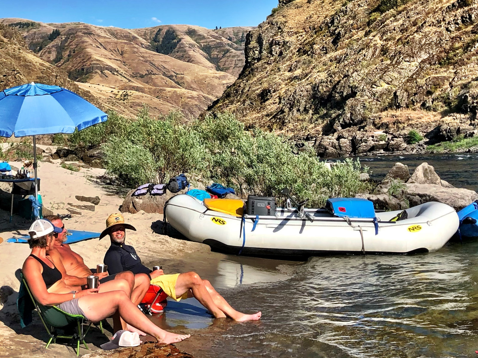 family-camp- parents-relaxing-on-river