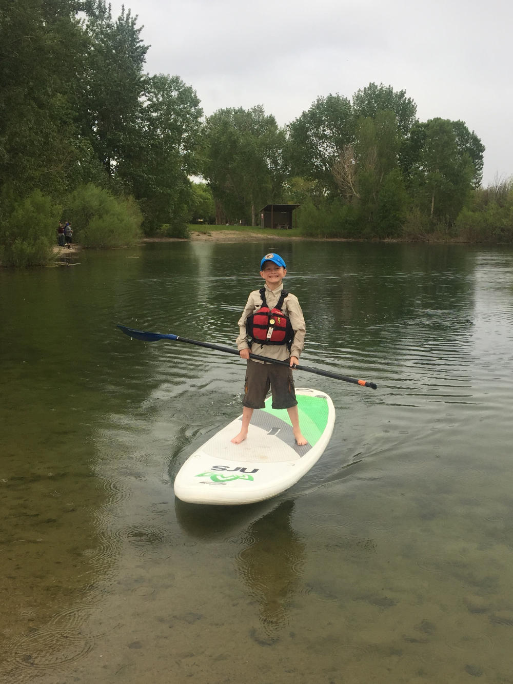 family-camp-boy-on-standup-paddle-board