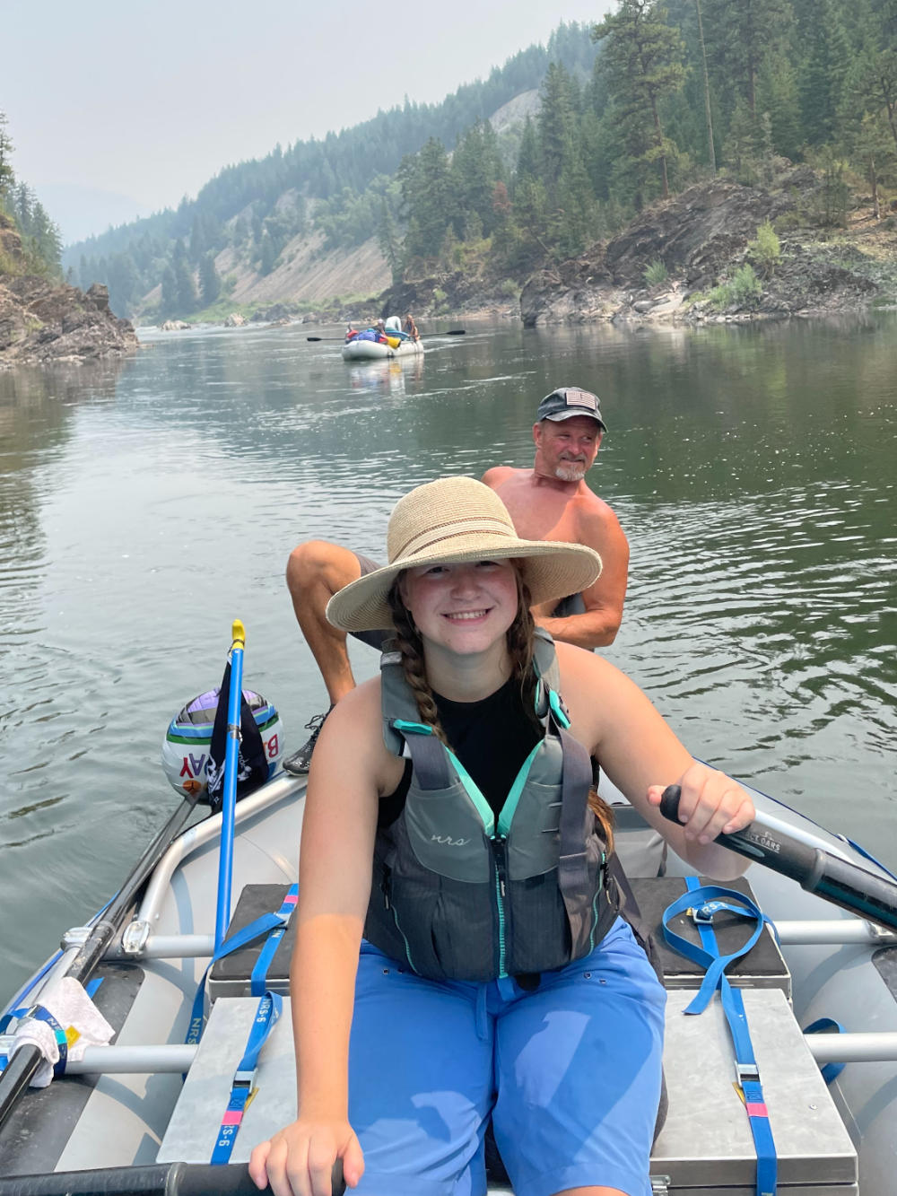 family-camp-girl-rowing-raft