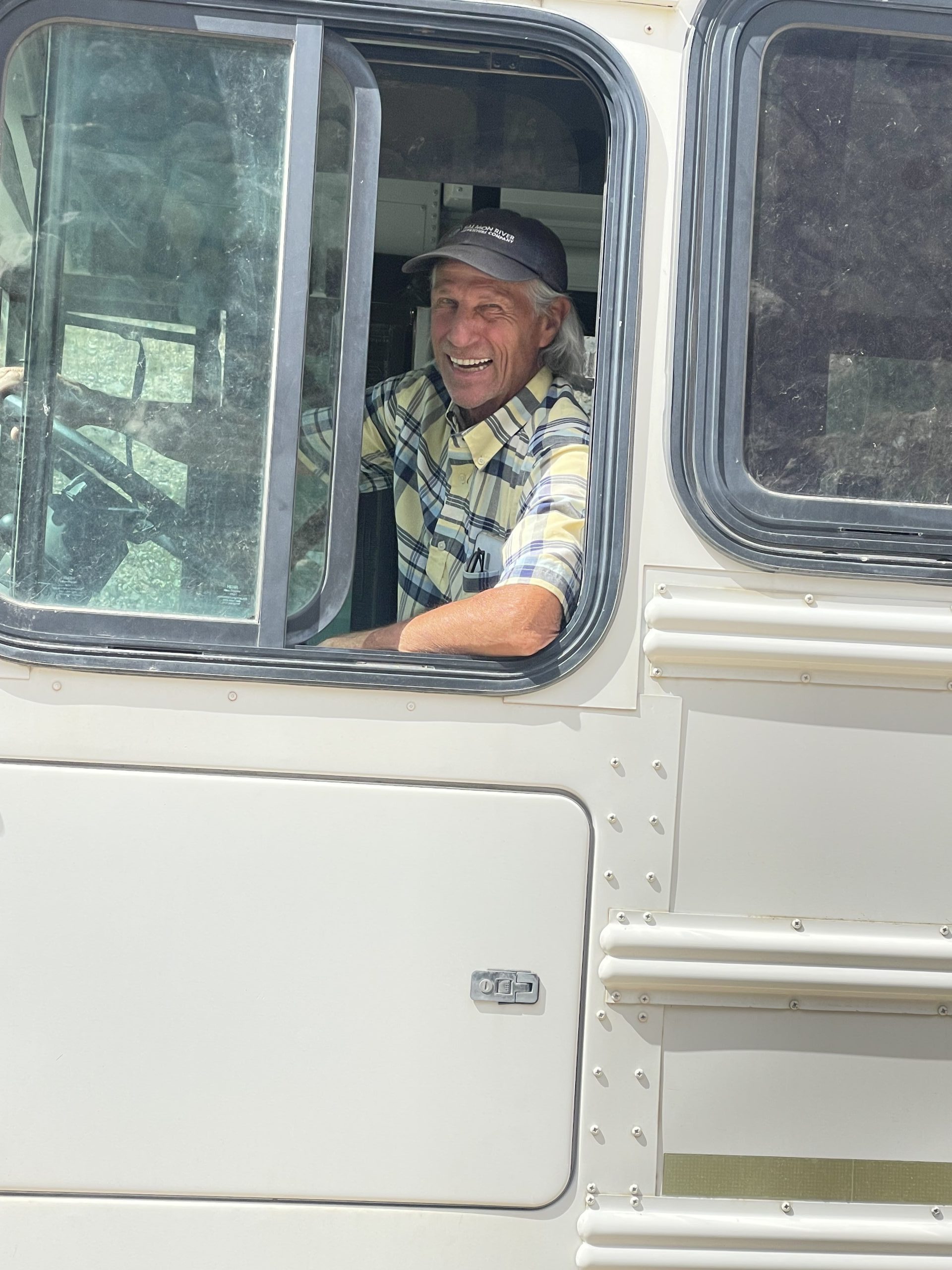 River guide smiling inside a camper before a Salmon River trip.