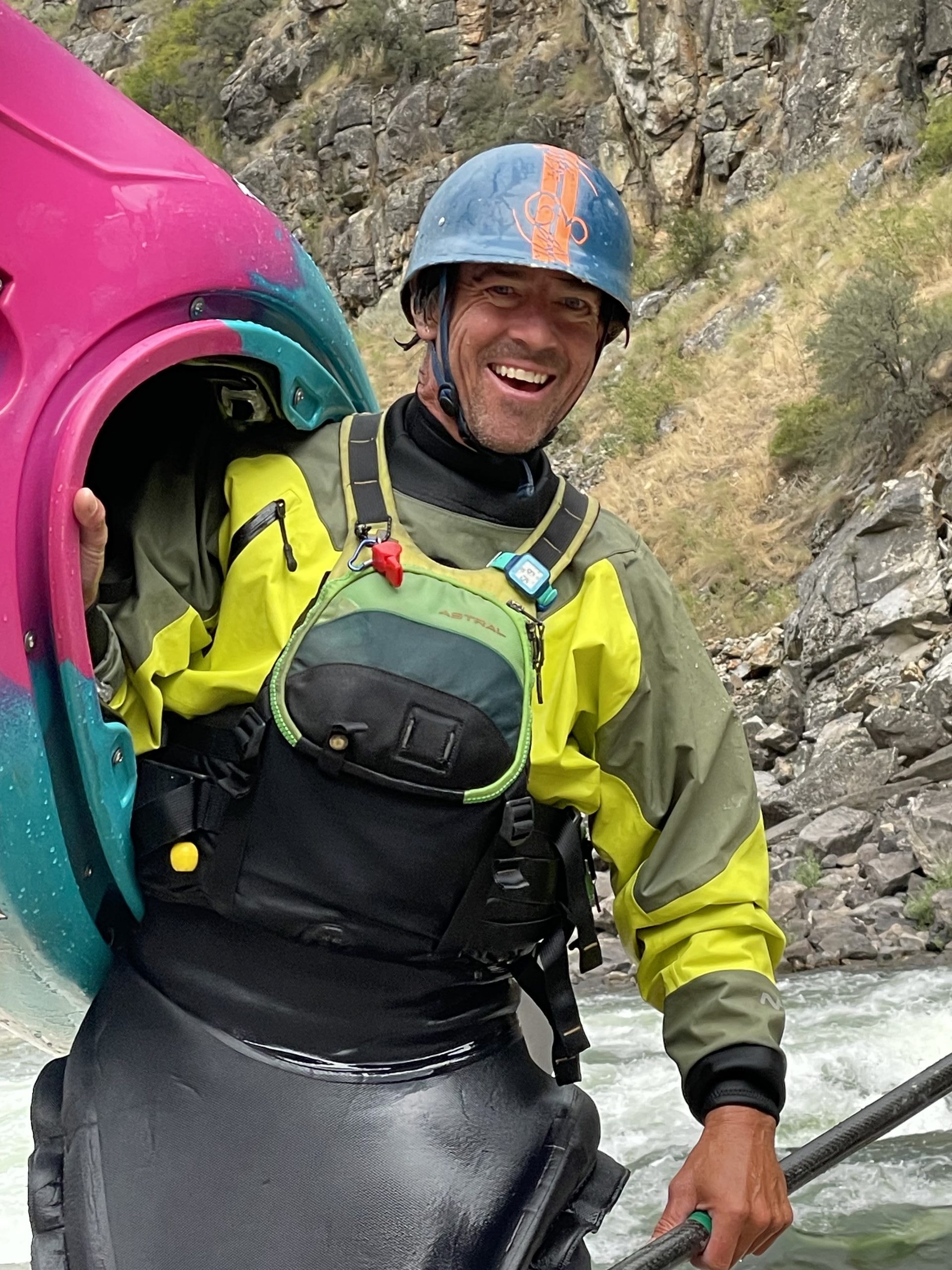 Tommy Hilleke, owner and guide, smiling while holding a kayak on the Salmon River.